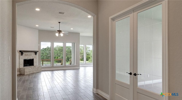 633 Vale Ct, New Braunfels, TX 78132 - unfurnished living room featuring arched walkways, recessed lighting, ceiling fan, dark wood-type flooring, and french doors