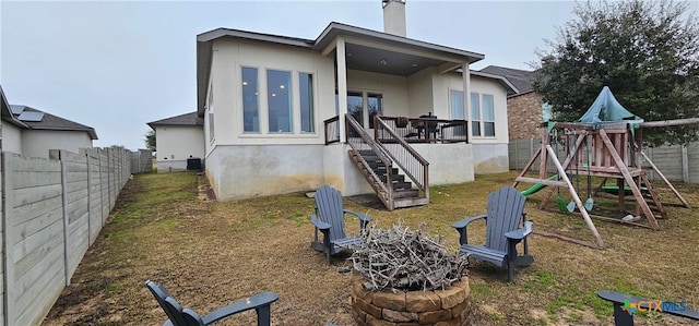 633 Vale Ct, New Braunfels, TX 78132 - rear view of house featuring a playground, a fenced backyard, a chimney, and stairway
