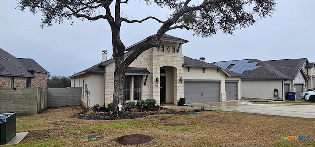 633 Vale Ct, New Braunfels, TX 78132 - french provincial home featuring stone siding, a garage, concrete driveway, a chimney, and stucco siding