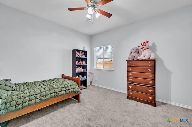 carpeted bedroom with ceiling fan and baseboards