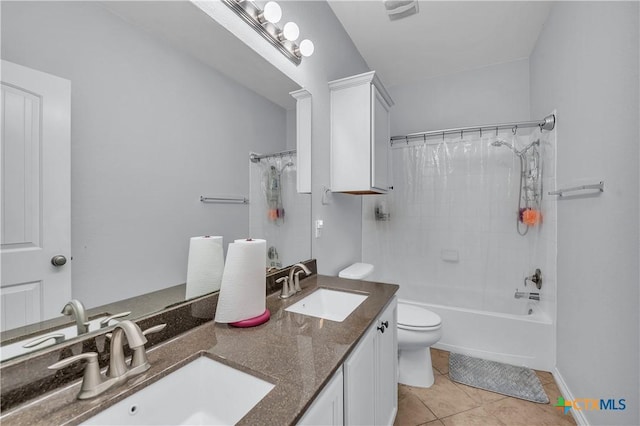 full bathroom featuring tile patterned flooring, double vanity, toilet, and a sink