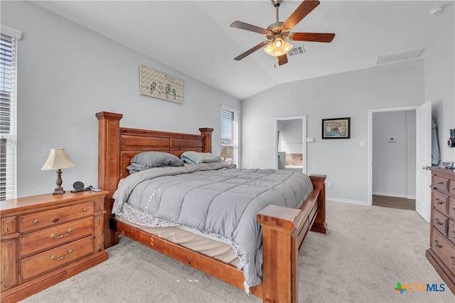 bedroom with visible vents, light carpet, lofted ceiling, baseboards, and ceiling fan