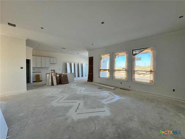 unfurnished living room with ornamental molding, visible vents, and concrete flooring