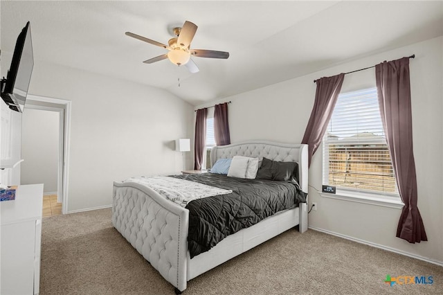 carpeted bedroom with ceiling fan, baseboards, and lofted ceiling