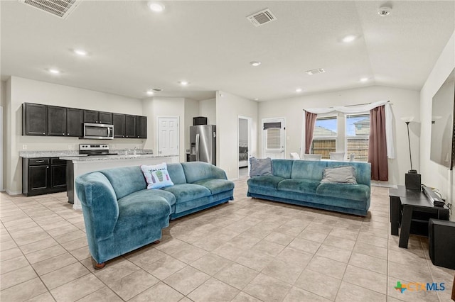 living area with light tile patterned floors, recessed lighting, and visible vents