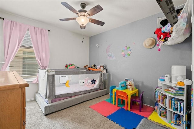 carpeted bedroom featuring baseboards and ceiling fan