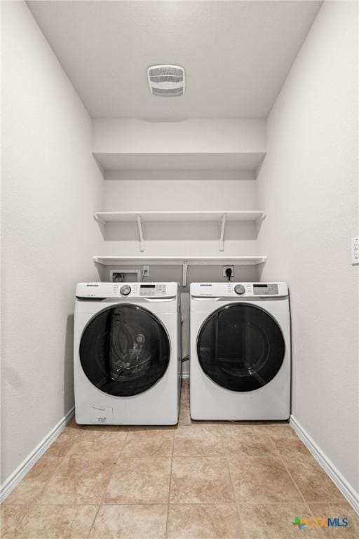 laundry room featuring visible vents, baseboards, washing machine and dryer, and laundry area