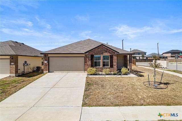 ranch-style home with brick siding, concrete driveway, central AC, a front yard, and an attached garage