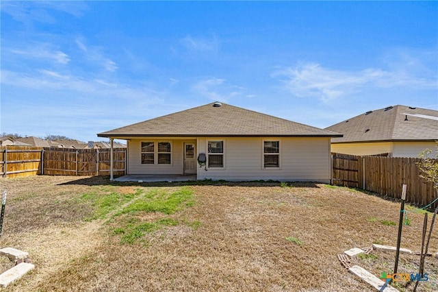 back of property featuring a patio, a lawn, and a fenced backyard