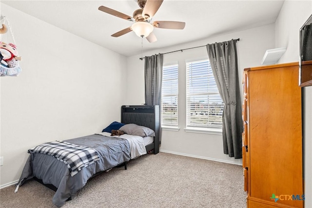 bedroom with baseboards, light carpet, and a ceiling fan