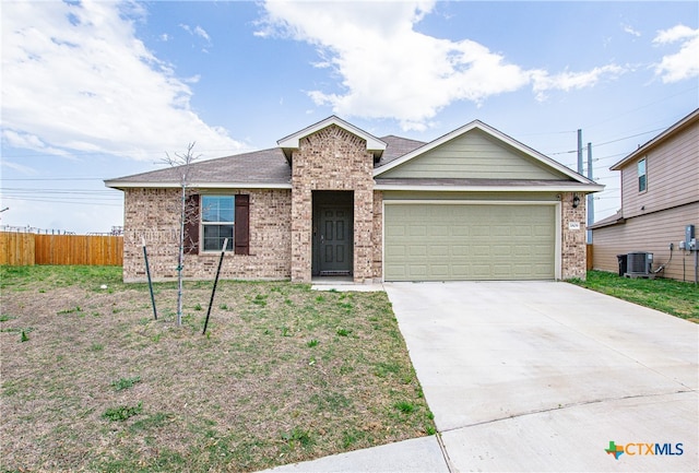 ranch-style home featuring a garage and central AC