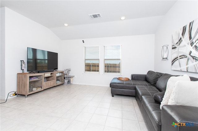 living room with lofted ceiling and light tile patterned floors