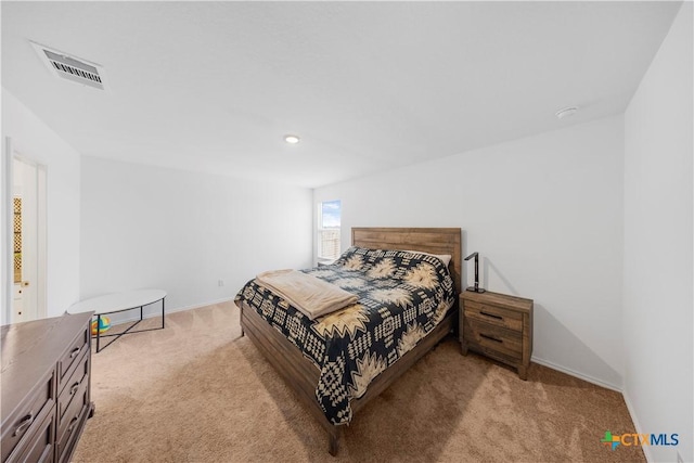 bedroom with light colored carpet, baseboards, and visible vents