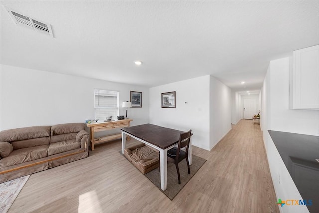 dining space with recessed lighting, light wood-style flooring, and visible vents
