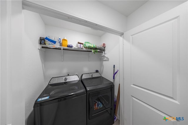 laundry area featuring washing machine and dryer and laundry area
