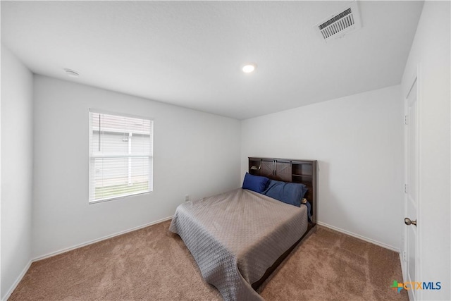 carpeted bedroom featuring baseboards and visible vents