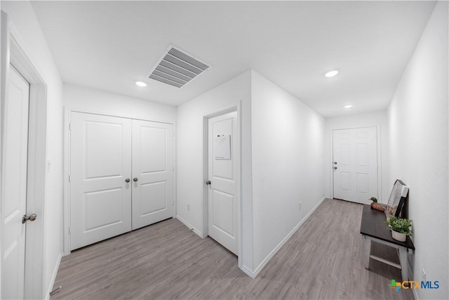 hall with light wood-type flooring, recessed lighting, baseboards, and visible vents