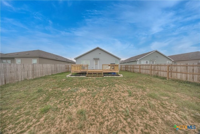 view of yard with a wooden deck and a fenced backyard