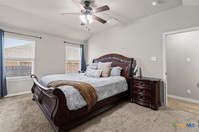 bedroom featuring multiple windows, light colored carpet, and vaulted ceiling