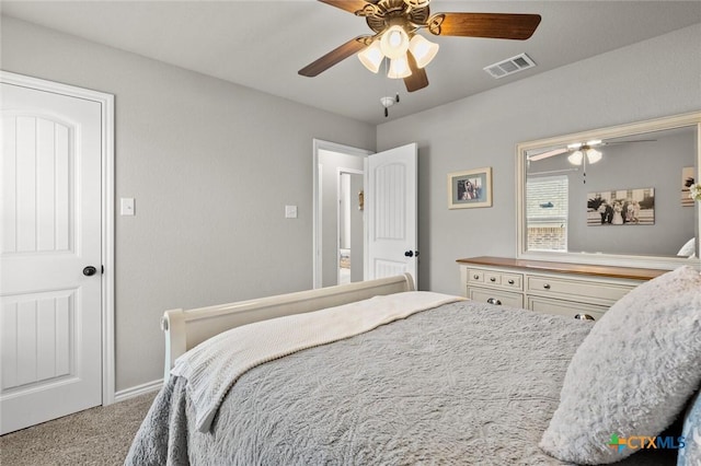 carpeted bedroom with a ceiling fan and visible vents