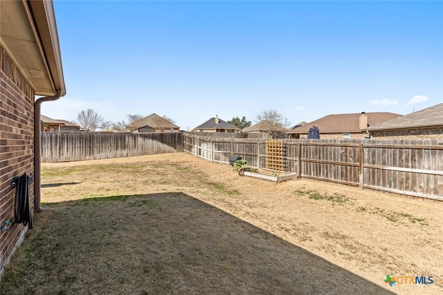 view of yard with a fenced backyard