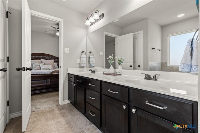 full bathroom featuring double vanity, a ceiling fan, ensuite bathroom, and a sink