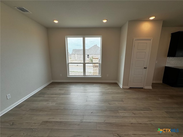 spare room featuring wood-type flooring