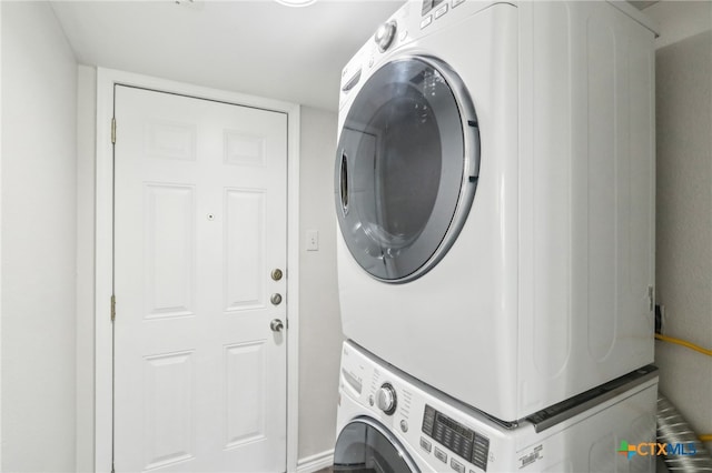 laundry area with stacked washer and clothes dryer and laundry area