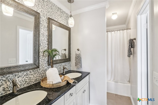 full bath with crown molding, decorative backsplash, and a sink