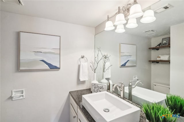 bathroom featuring vanity, toilet, a notable chandelier, and visible vents
