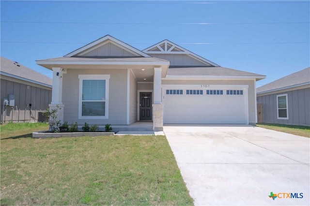3707 Mccleland Creek Trl, Temple, TX 76502 - view of front facade with an attached garage, a front yard, and concrete driveway
