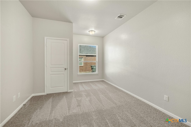 spare room with light carpet