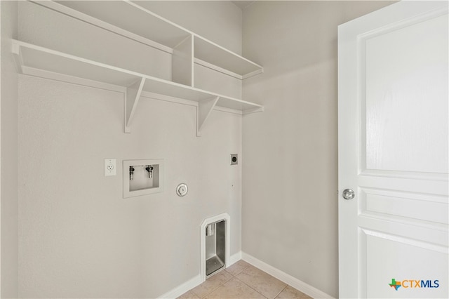 washroom with electric dryer hookup, gas dryer hookup, light tile patterned floors, and washer hookup