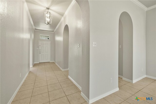 6109 Worthing Dr, Temple, TX 76502 - hall featuring ornamental molding, light tile patterned flooring, arched walkways, and baseboards