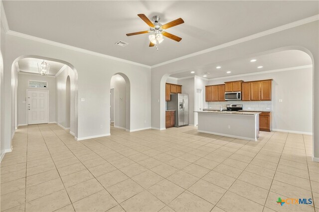6109 Worthing Dr, Temple, TX 76502 - kitchen with stainless steel appliances, open floor plan, arched walkways, a ceiling fan, and ornamental molding