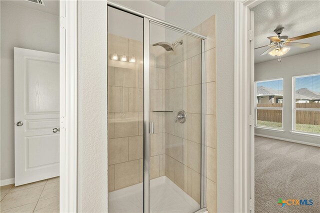 6109 Worthing Dr, Temple, TX 76502 - bathroom featuring a ceiling fan, a shower stall, baseboards, and tile patterned flooring