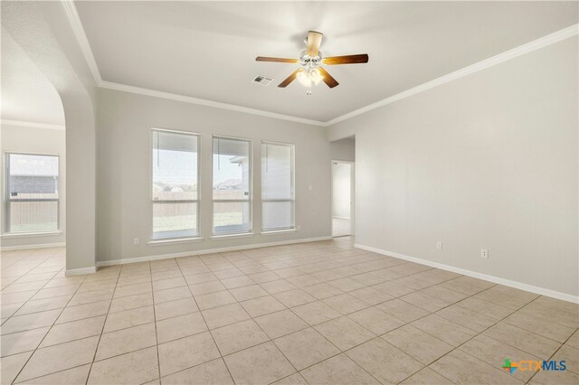 6109 Worthing Dr, Temple, TX 76502 - empty room featuring ceiling fan, light tile patterned flooring, ornamental molding, arched walkways, and baseboards