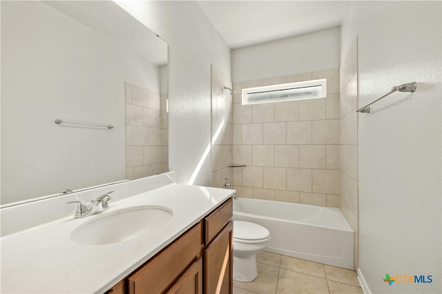 full bathroom with tile patterned floors, vanity, tiled shower / bath, and toilet