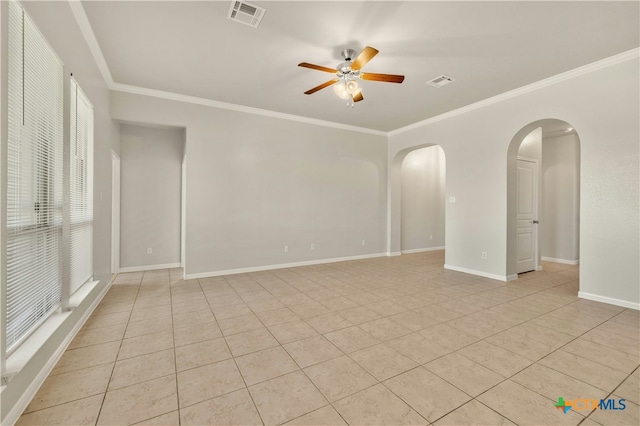 spare room featuring ceiling fan, light tile patterned flooring, and crown molding