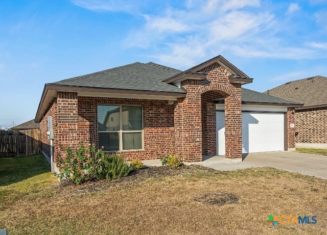 view of front facade with a garage and a front yard