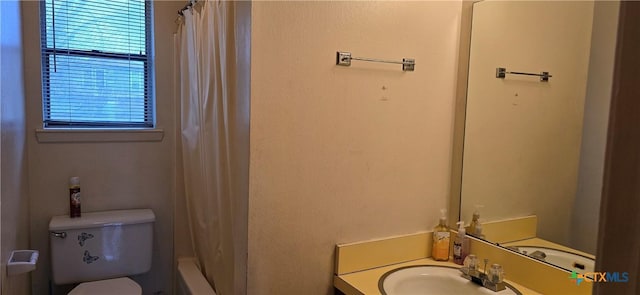 full bathroom with vanity, shower / bath combination with curtain, and toilet