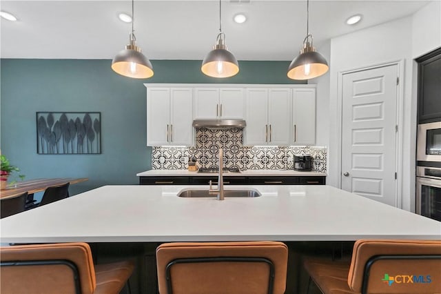 1620 Craftsman, New Braunfels, TX 78132 - kitchen featuring light countertops, decorative backsplash, pendant lighting, stainless steel oven, and recessed lighting