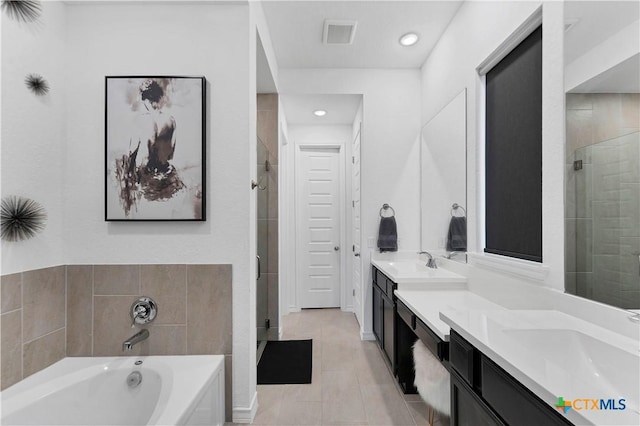 1620 Craftsman, New Braunfels, TX 78132 - bathroom with double vanity, a garden tub, a shower stall, tile patterned flooring, and recessed lighting