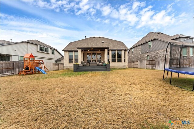 1620 Craftsman, New Braunfels, TX 78132 - rear view of house featuring a trampoline, a fenced backyard, and a playground