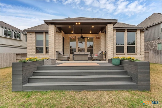 1620 Craftsman, New Braunfels, TX 78132 - back of property featuring a ceiling fan, brick siding, a wooden deck, and an outdoor hangout area