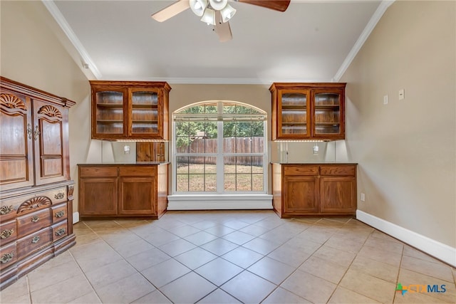 interior space with ceiling fan, light tile patterned flooring, and crown molding