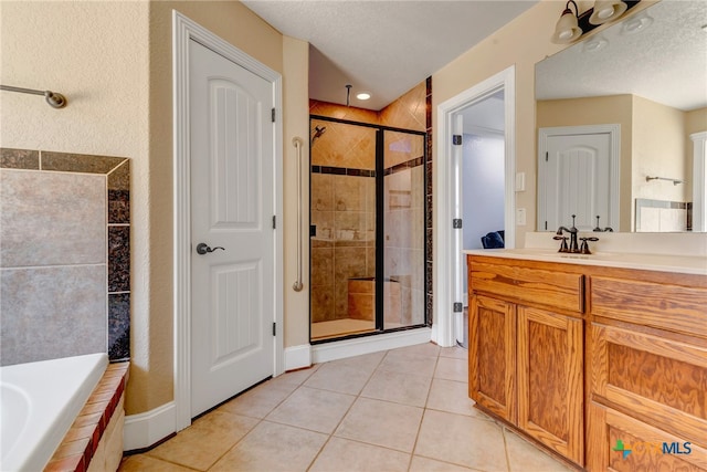 bathroom featuring tile patterned floors, vanity, a textured ceiling, and independent shower and bath