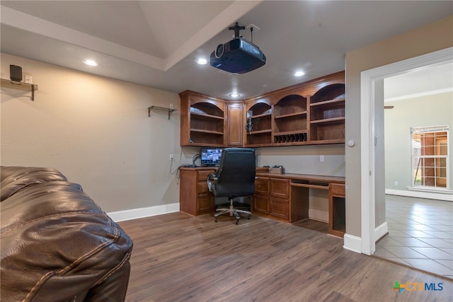 home office featuring built in desk and dark wood-type flooring