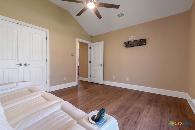 bedroom with ceiling fan, vaulted ceiling, dark wood-type flooring, and a closet