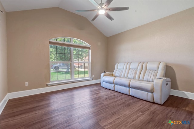 living room with lofted ceiling, ceiling fan, and dark wood-type flooring